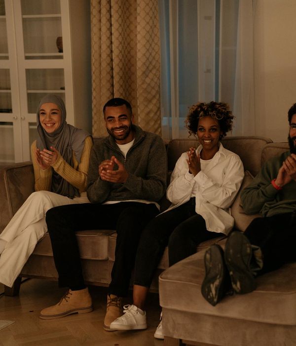 A diverse group of people smiling together in comfortable clothes